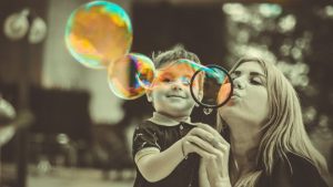 Woman and child blowing bubbles